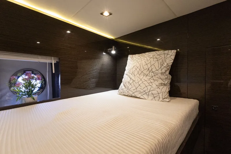Slide: The Image of Luxurious cabin interior of 2019 Cruisers Yachts 50 Cantius with elegant bedding and porthole view. - 42