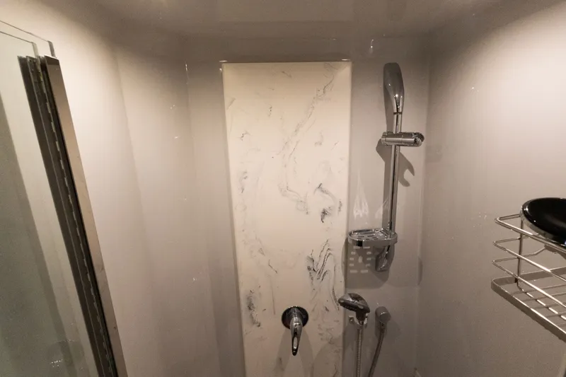 Slide: The Image of Shower area in 2019 Cruisers Yachts 50 Cantius with marble panel and chrome fixtures. - 49