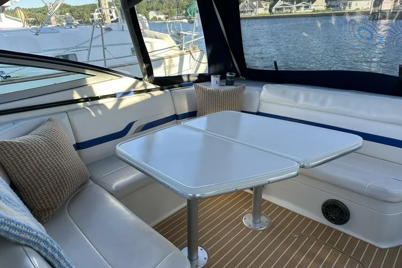 Slide: The Image of Interior of 2002 Formula 330 Sun Sport boat with seating and table by the water. - 12