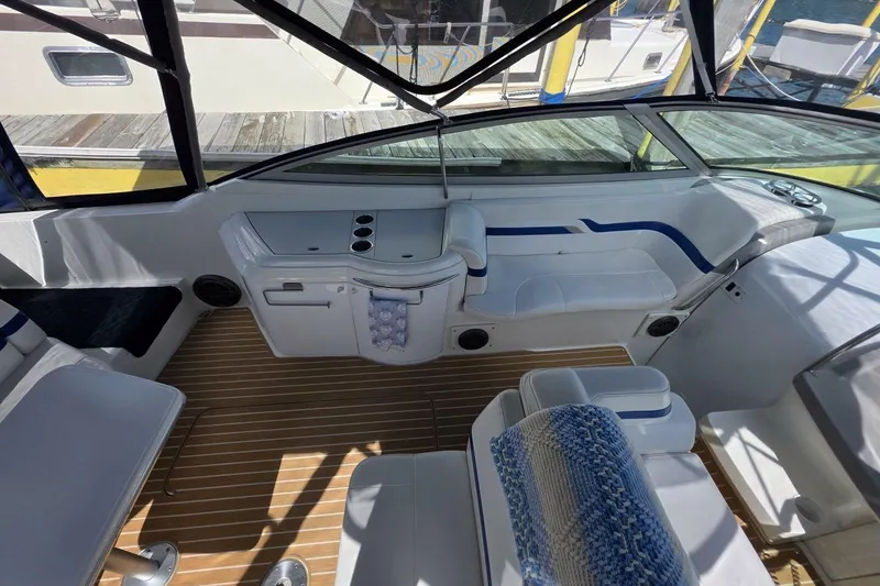 Slide: The Image of 2002 Formula 330 Sun Sport boat interior with white seating and wooden flooring. - 14
