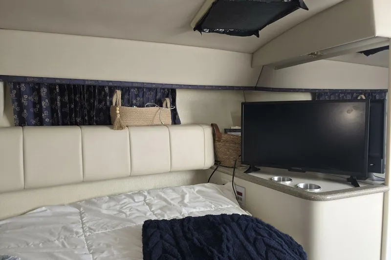 Slide: The Image of Interior of 2002 Formula 330 Sun Sport with bed, TV, and storage basket. - 22