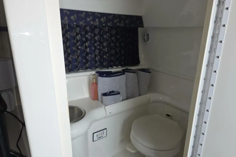 Slide: The Image of Interior of 2002 Formula 330 Sun Sport boat bathroom with toilet and sink. - 24