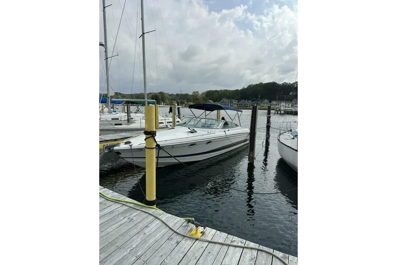 Slide: The Image of 2002 Formula 330 Sun Sport boat docked at a marina on a cloudy day. - 3