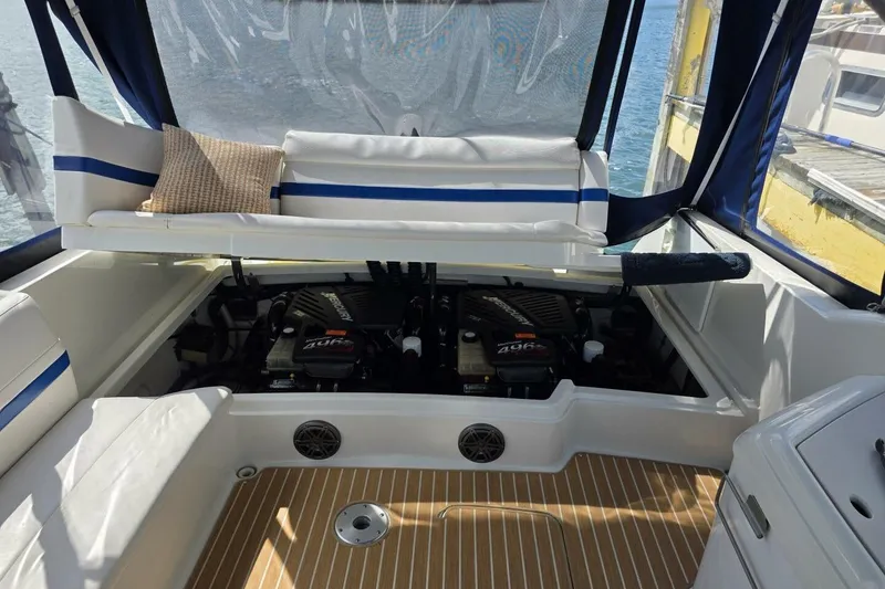 Slide: The Image of 2002 Formula 330 Sun Sport boat engine compartment with seating and marine equipment. - 33