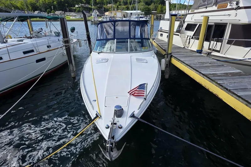 Slide: The Image of 2002 Formula 330 Sun Sport boat docked with American flag, surrounded by other boats. - 4