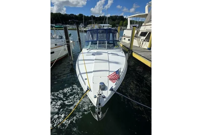 Slide: The Image of 2002 Formula 330 Sun Sport boat docked with American flag, clear sky background. - 5
