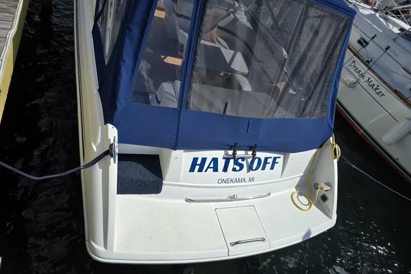 Slide: The Image of 2002 Formula 330 Sun Sport boat docked, featuring blue canopy and "HATSOFF" name. - 9