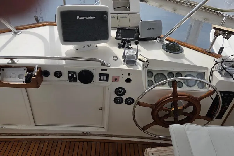 Slide: The Image of Helm of 1989 Grand Banks 42 Classic with navigation equipment and wooden steering wheel. - 12