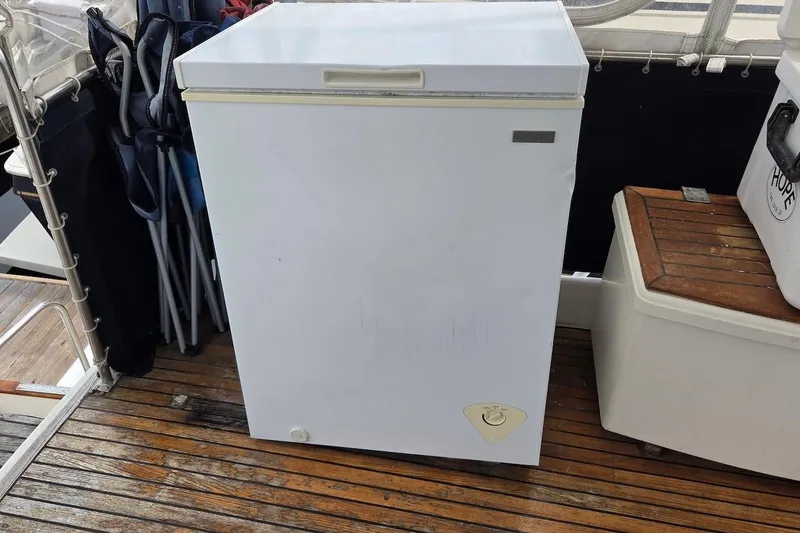 Slide: The Image of White chest freezer on 1989 Grand Banks 42 Classic boat deck. - 13
