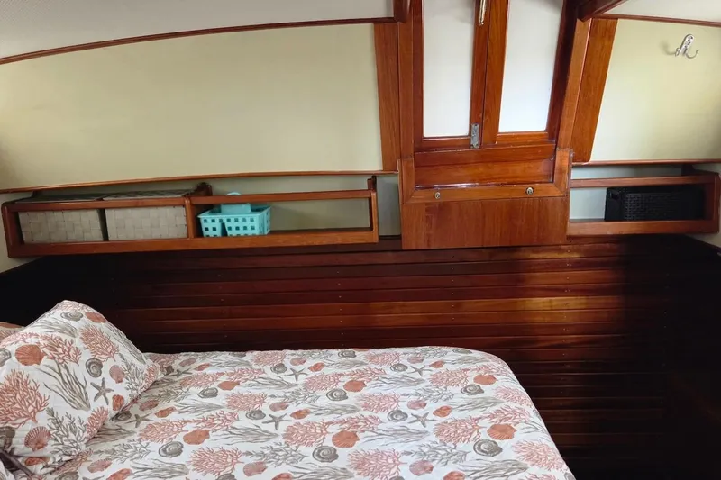 Slide: The Image of Cozy cabin interior of 1989 Grand Banks 42 Classic with floral bedding and wooden accents. - 23