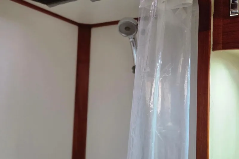 Slide: The Image of Shower area in 1989 Grand Banks 42 Classic yacht with curtain and wooden trim. - 26