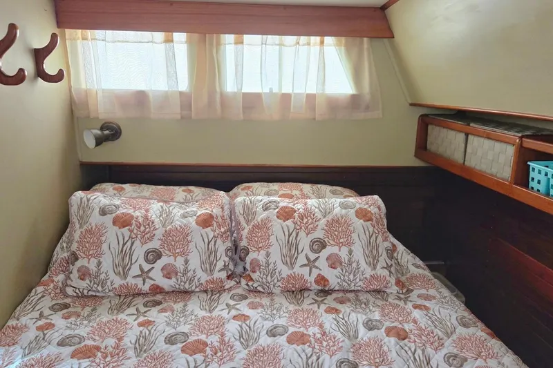 Slide: The Image of Cozy bedroom in 1989 Grand Banks 42 Classic yacht with nautical-themed bedding. - 28
