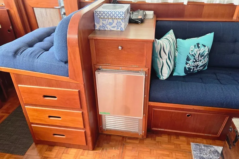 Slide: The Image of Interior of 1989 Grand Banks 42 Classic with blue cushions and wooden cabinetry. - 33
