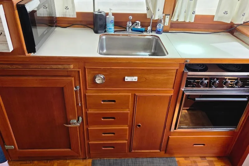 Slide: The Image of Galley kitchen in 1989 Grand Banks 42 Classic yacht with wood cabinetry and appliances. - 35
