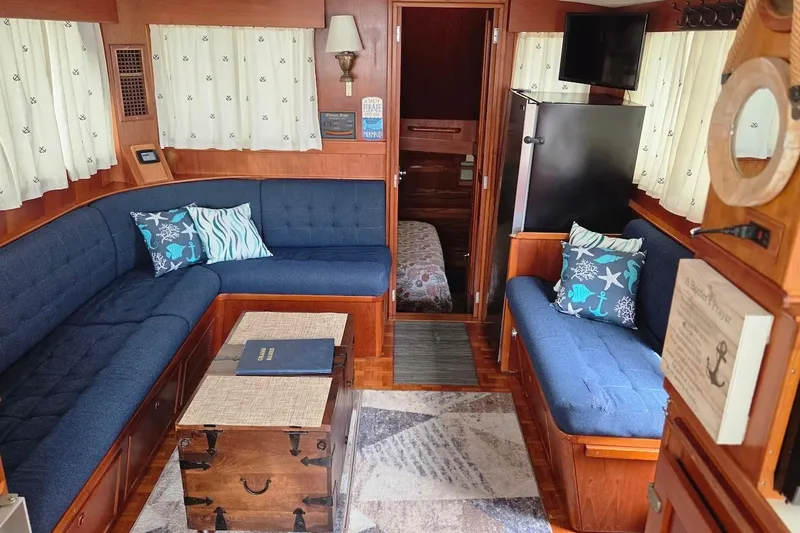 Slide: The Image of Interior of 1989 Grand Banks 42 Classic yacht with cozy seating and nautical decor. - 37