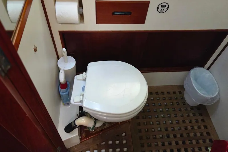 Slide: The Image of Bathroom interior of 1989 Grand Banks 42 Classic yacht, featuring toilet and wooden flooring. - 41