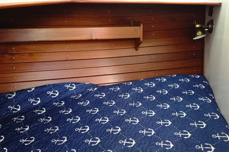 Slide: The Image of Cozy cabin interior of 1989 Grand Banks 42 Classic with nautical-themed bedding. - 43