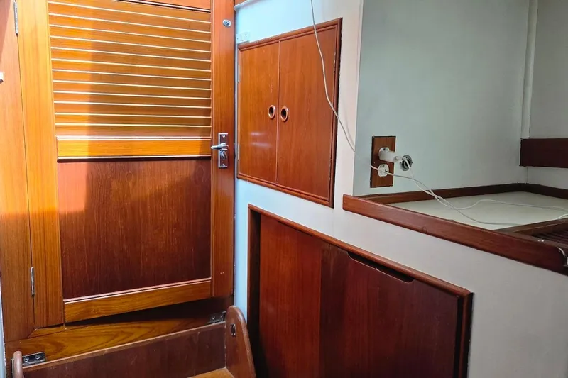 Slide: The Image of Interior of 1989 Grand Banks 42 Classic yacht with wooden cabinetry and door. - 45