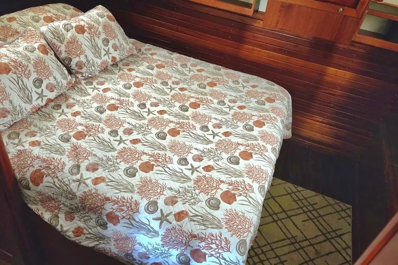 Slide: The Image of Cozy cabin bedroom in 1989 Grand Banks 42 Classic yacht with nautical-themed bedding. - 46