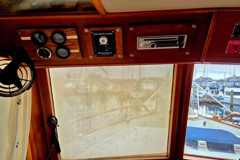 Slide: The Image of Interior view of 1989 Grand Banks 42 Classic yacht with control panel and marina backdrop. - 47