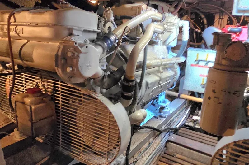 Slide: The Image of Engine room of a 1989 Grand Banks 42 Classic, featuring complex machinery and piping. - 59