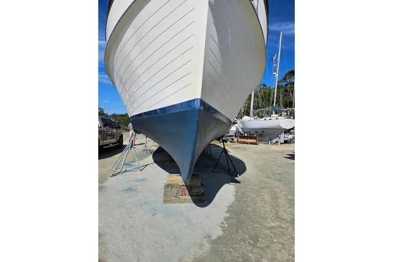 Slide: The Image of 1989 Grand Banks 42 Classic yacht on dry dock, showcasing its hull design. - 64