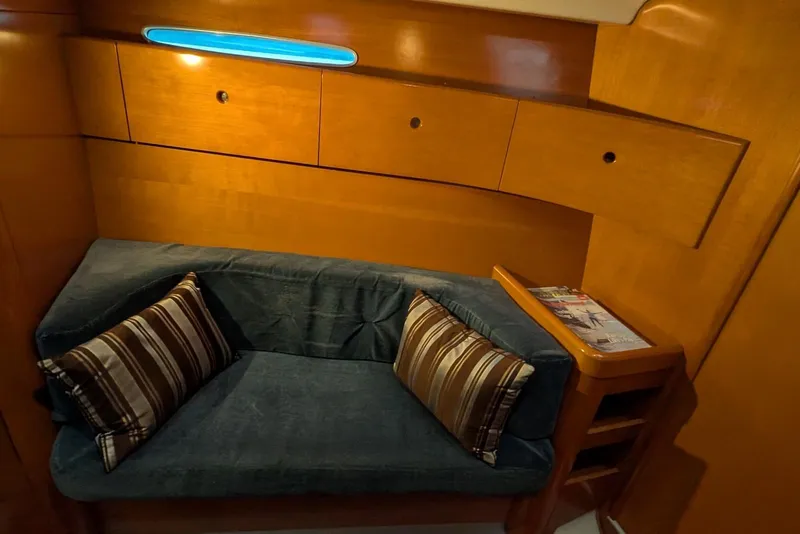 Slide: The Image of 1997 Beneteau First 42s7 yacht interior with cozy seating and wooden cabinetry. - 13