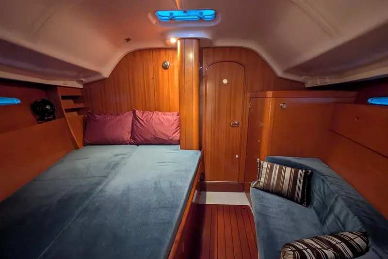 Slide: The Image of Interior of 1997 Beneteau First 42s7 yacht with cozy wooden cabin and blue upholstery. - 14