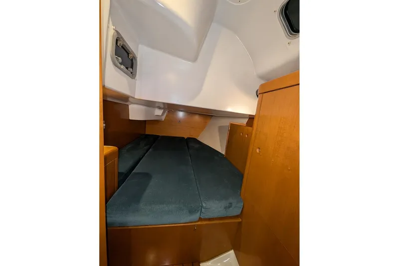 Slide: The Image of Cozy cabin interior of 1997 Beneteau First 42s7 sailboat with wooden finish and cushioned berth. - 17