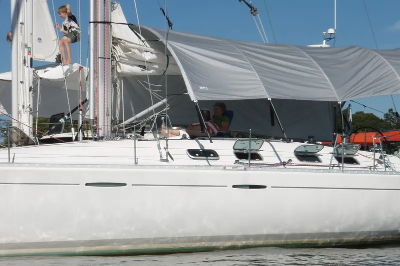 Slide: The Image of 1997 Beneteau First 42s7 sailboat with sunshade, people relaxing onboard. - 2