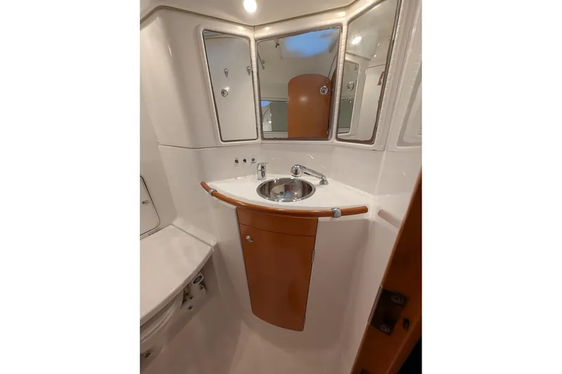 Slide: The Image of Bathroom interior of 1997 Beneteau First 42s7 yacht, featuring sink and mirrors. - 21