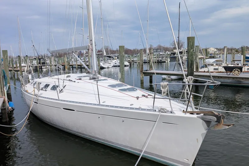 Slide: The Image of 1997 Beneteau First 42s7 sailboat docked at a marina, surrounded by other boats. - 3