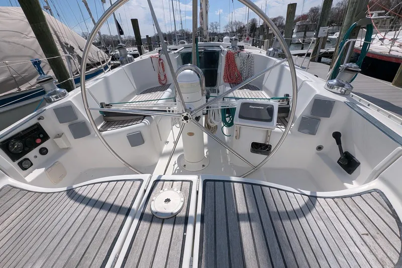 Slide: The Image of Cockpit of 1997 Beneteau First 42s7 sailboat with steering wheel and navigation equipment. - 5