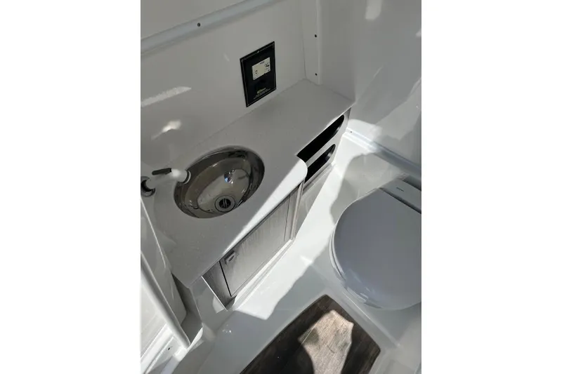 Slide: The Image of 2021 Monterey M6 boat bathroom with sink and toilet, featuring modern design. - 7