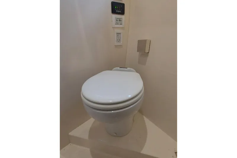 Slide: The Image of Toilet in 2004 Carver 570 Voyager Pilothouse yacht bathroom, featuring modern controls. - 32