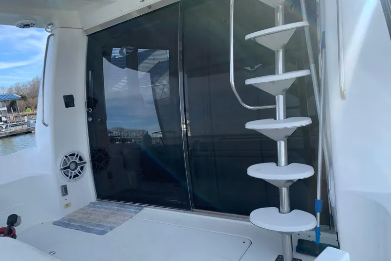 Slide: The Image of 2004 Carver 570 Voyager Pilothouse yacht with spiral staircase and glass door. - 35