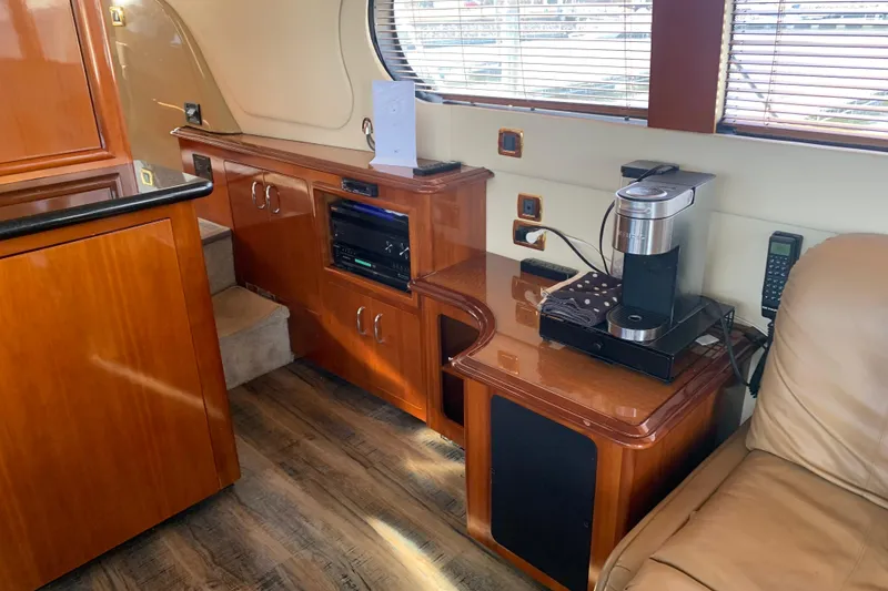 Slide: The Image of Interior of 2004 Carver 570 Voyager Pilothouse with wooden cabinetry and coffee maker. - 36