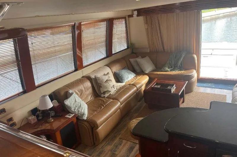 Slide: The Image of Luxurious interior of 2004 Carver 570 Voyager Pilothouse with leather seating and large windows. - 19