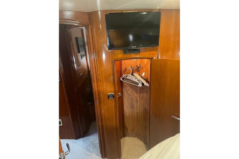 Slide: The Image of Interior of 2004 Carver 570 Voyager Pilothouse with TV and wooden closet. - 22