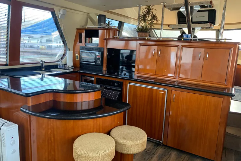 Slide: The Image of Luxurious kitchen interior of 2004 Carver 570 Voyager Pilothouse yacht with wood cabinetry. - 37