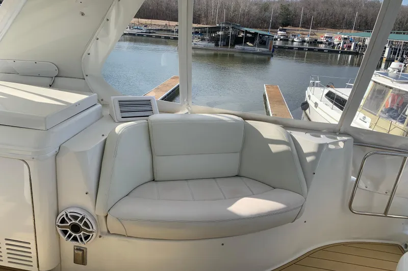 Slide: The Image of Luxurious seating area on a 2004 Carver 570 Voyager Pilothouse yacht, docked at a marina. - 39