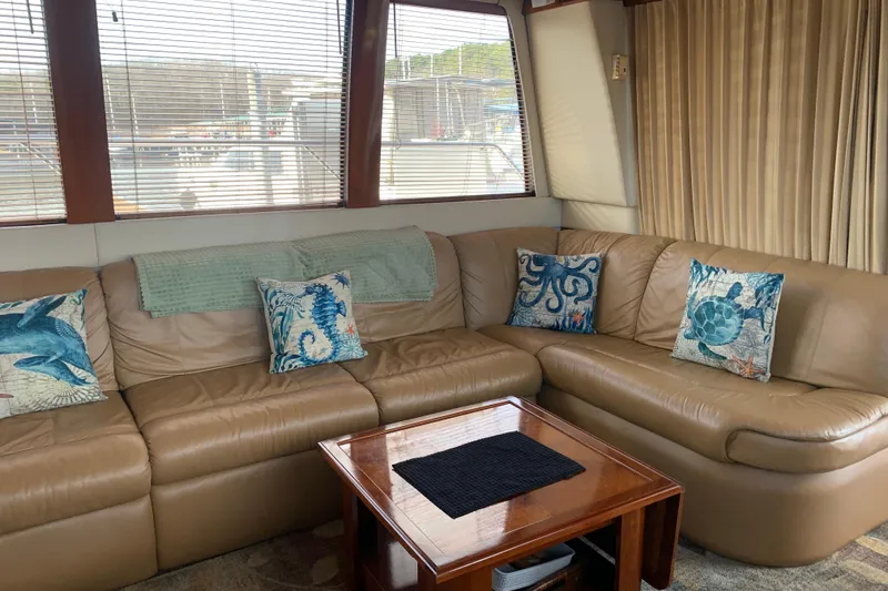 Slide: The Image of Luxurious interior of 2004 Carver 570 Voyager Pilothouse with leather seating and nautical-themed pillows. - 42