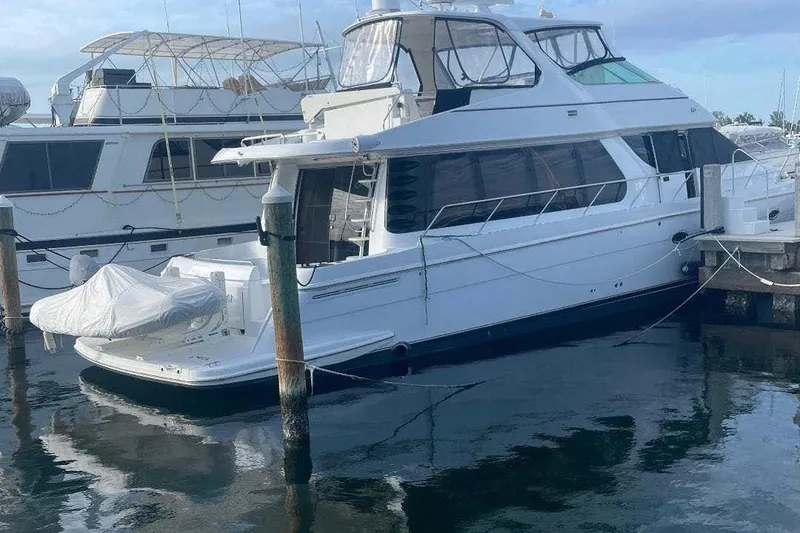 Slide: The Image of 2004 Carver 570 Voyager Pilothouse yacht docked at marina, side view. - 9