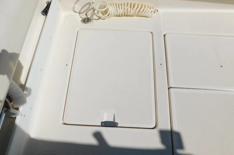 Slide: The Image of 1993 Tiara Yachts 3100 Open deck with storage hatch and coiled hose. - 14