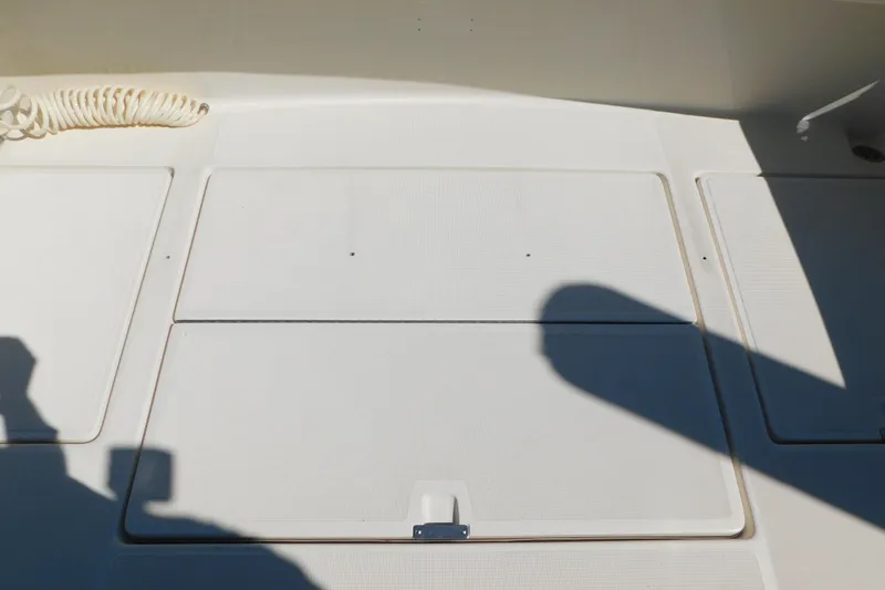 Slide: The Image of Deck of 1993 Tiara Yachts 3100 Open with storage compartments and coiled rope. - 16