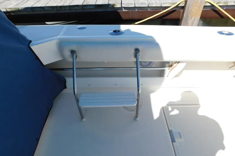 Slide: The Image of 1993 Tiara Yachts 3100 Open boat deck with ladder and blue cover. - 22