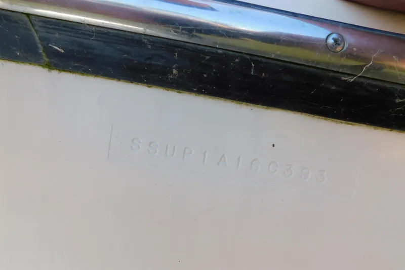 Slide: The Image of 1993 Tiara Yachts 3100 Open hull identification number on white surface. - 25