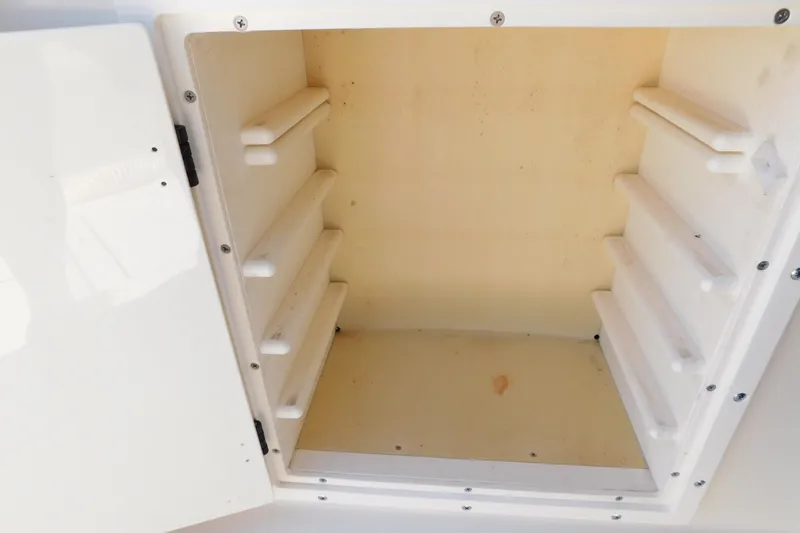 Slide: The Image of Storage compartment on a 1993 Tiara Yachts 3100 Open boat, featuring multiple shelves. - 28