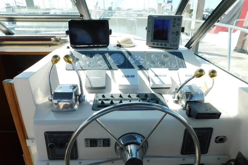Slide: The Image of 1993 Tiara Yachts 3100 Open helm with navigation instruments and steering wheel. - 34