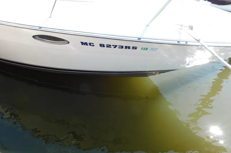 Slide: The Image of 1993 Tiara Yachts 3100 Open boat docked, displaying registration number MC 8273RS. - 4